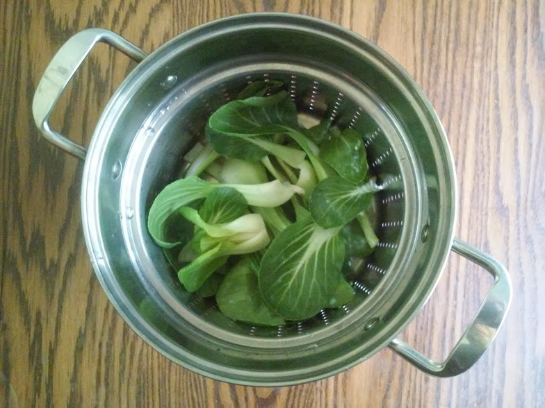 Bok Choy leaves in a colander insert
